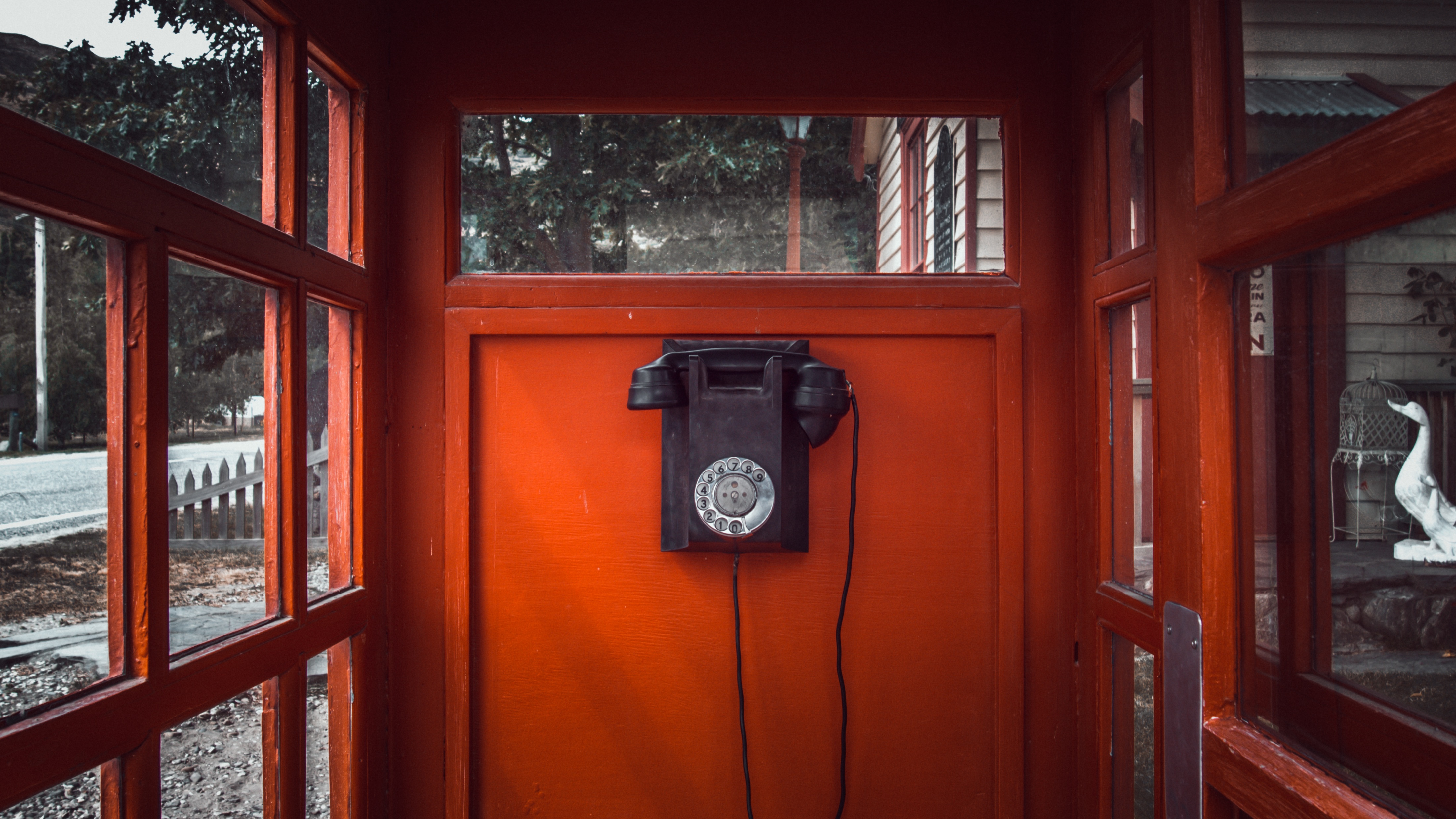 old- fashioned telephone in a red phone box